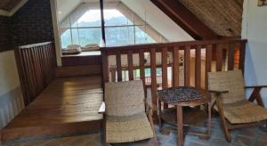 a room with a table and chairs and a window at Ncie property in Cangkuang