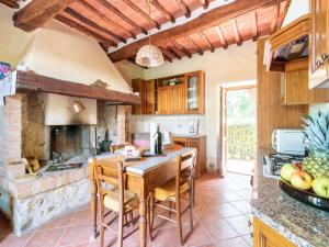 a kitchen with a table and chairs in a room at Sun-kissed holiday home in Monti di Sotto