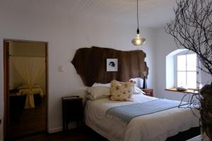 Ένα ή περισσότερα κρεβάτια σε δωμάτιο στο The Hudson Guesthouse & Suites