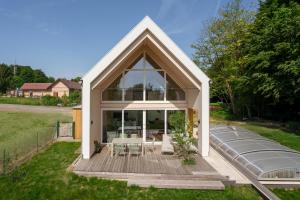 a house with a deck with a large window at Am Grassnitzberg in Grassnitzberg