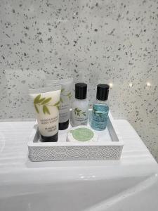 a tray with three products sitting on a sink at Luxury studio flat, Skipton in Skipton