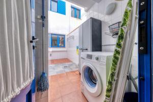 a laundry room with a washing machine in a house at El Rincon de Famara in Famara