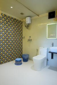 a bathroom with a toilet and a sink at Vista Villa- A Riverside Villa in Alibaug in Mamnoli +28 photos
