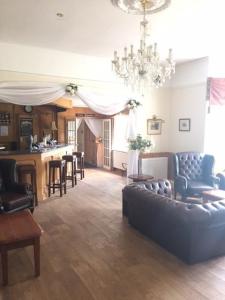 
a living room filled with furniture and a fireplace at Leeford Place Hotel in Battle

