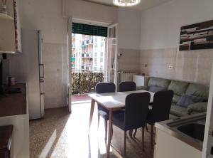 a kitchen and living room with a table and chairs at Cruise Lodge Vista Mare in Genoa