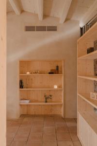 a room with wooden shelves on the wall at Casa boutique a Vilamacolum in Vilamacolum +52 photos