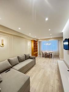 a living room with a couch and a table at Stylishapartment in Chişinău