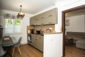a kitchen and a living room with a table at Apartment in Odorheiu Secuiesc in Odorheiu Secuiesc