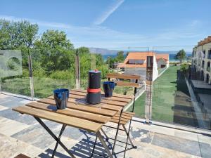 a wooden table with black cylinders on top of a roof at Pes Na Area Fisterra 22 in Fisterra