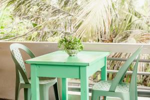 a blue table with two chairs and a potted plant at Sea You Surfers Nest! Hello to waves in a minute walk in Kumbalgama