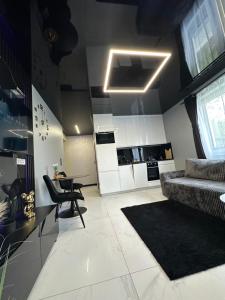 a living room with a bed and a table and chairs at Apart LUXE - Faktura VAT , Parking w garażu podziemnym , Taras in Koszalin