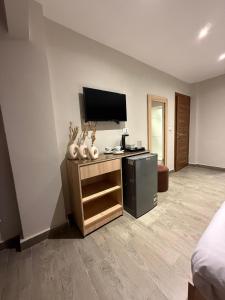 a room with a flat screen tv on a wall at Zlato Pyramids View INN in Cairo