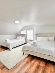 due letti in una camera da letto con pavimenti in legno di DC Getaway Cozy 4BR Oasis by Metro and Airports ad Arlington