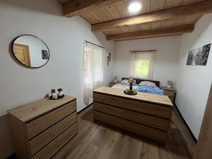 a bedroom with a bed and a mirror on the wall at Ferienwohnung Storck in Bad Bleiberg