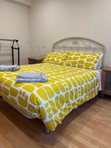 a bed with a yellow and white comforter and pillows at Origen HARO ventilla in Haro +9 photos