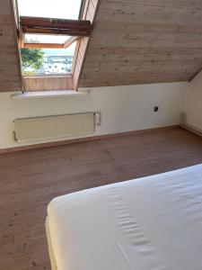 a bedroom with a white bed and a window at Udsigtsvilla Tambohus in Thyholm +7 photos