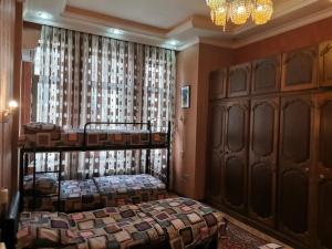 a bedroom with two beds and a chandelier at Baku Hostel in Baku