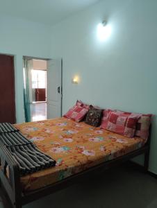 a bedroom with a bed with a flower blanket at A Cozy Homestay in Coimbatore in Coimbatore