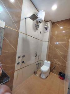 a bathroom with a toilet and a shower at prabh aasra in Ayodhya