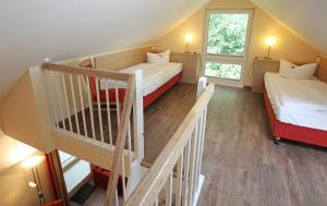 mały pokój z 2 łóżkami i schodami w obiekcie Ferienzentrum Trassenmoor w Trassenheide