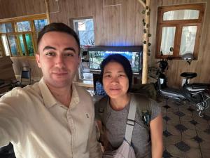 a man and a woman posing for a picture at Soy Buyi Garden in Fergana