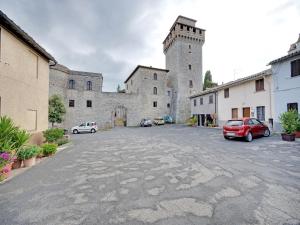 a large castle with cars parked in a parking lot at Mansion in Prodo near Lake Bolsena in Prodo +26 photos