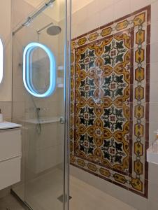 a shower with a glass door in a bathroom at Sand - Rooftop Views, Wine Cellar & Espresso in Senglea +10 photos