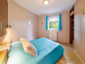 a bedroom with a blue bed and a window at Spa Cottage in Fagnes in Waimes +30 photos