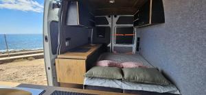 a bed in the back of an rv with the ocean at Van Master in Puerto del Rosario +6 photos