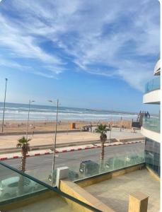 a view of the beach from a building with palm trees at Mehdia's Paradise in Kenitra