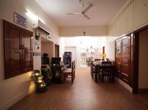 a dining room and living room with a table and chairs at The Harmony Circle - Jaipur in Jaipur
