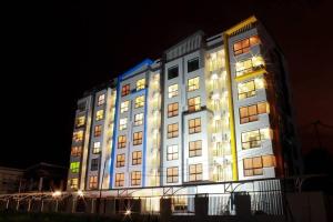 a large building with lights on it at night at The sea forest 101 in Rayong +3 photos