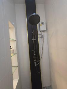 a shower in a bathroom with a black door at The sea forest 101 in Rayong