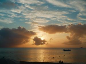 a sunset on the beach with a boat in the water at Date Villa Awaji in Sumoto +23 photos