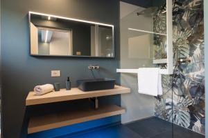 a bathroom with a sink and a mirror at Villa Sawian in Appiano sulla Strada del Vino +55 photos