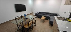 a living room with a glass table and a couch at Exquisite Flat in Martorell (Barcelona) in Martorell