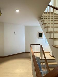 a staircase in a building with a microwave on the wall at Yukata Space  +15 photos