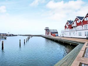 a body of water with houses and a lighthouse at Seaside Escape in Bagenkop - By Traum Ferienwohnungen in Bagenkop