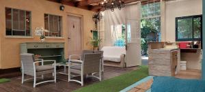 a patio with chairs and a table and a desk at Love & Lemons in Yesod Hamaala