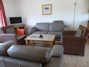a living room with a couch and a table at Haus Nordereck in Wustrow