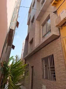 a building with a window on the side of it at Keur Moussa in Dakar