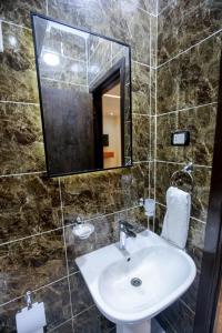 a bathroom with a sink and a mirror at Imperial Pyramids View Inn in Cairo +116 photos