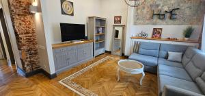 a living room with a couch and a tv at Al Pacino Family Lux Apartment in Rīga