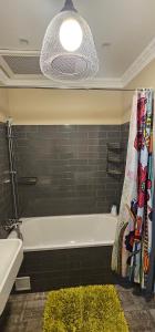a bathroom with a bath tub and a rug at Al Pacino Family Lux Apartment in Rīga +11 photos