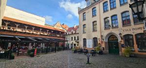 a cobblestone street in a city with many buildings at Al Pacino Family Lux Apartment in Rīga
