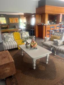 a living room with a couch and a coffee table at Koru Guesthouse in Pretoria