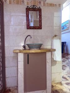 a bathroom with a sink and a mirror at Dar Noor Fès in Fez +38 photos