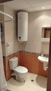a bathroom with a toilet and a sink at Apartment Photinia in Byala