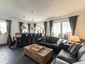 a living room with a couch and a table at Holiday Home Brixen near Skiwelt Slopes in Brixen im Thale