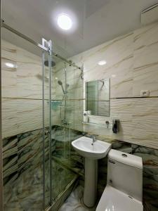 a bathroom with a toilet and a sink and a shower at Bulvar Hotel & Hostel in Samarkand +27 photos